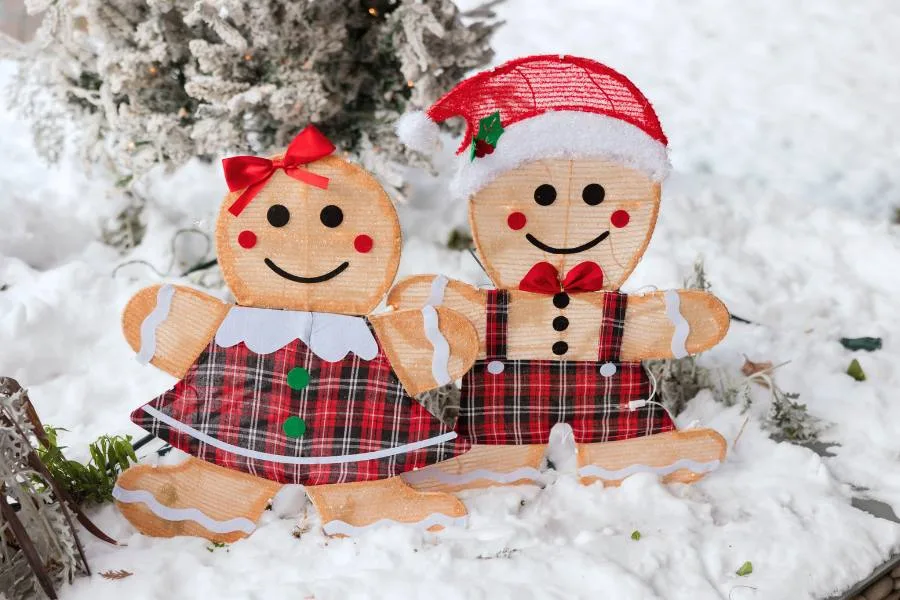 Two festive gingerbread cookie decorations in the snow